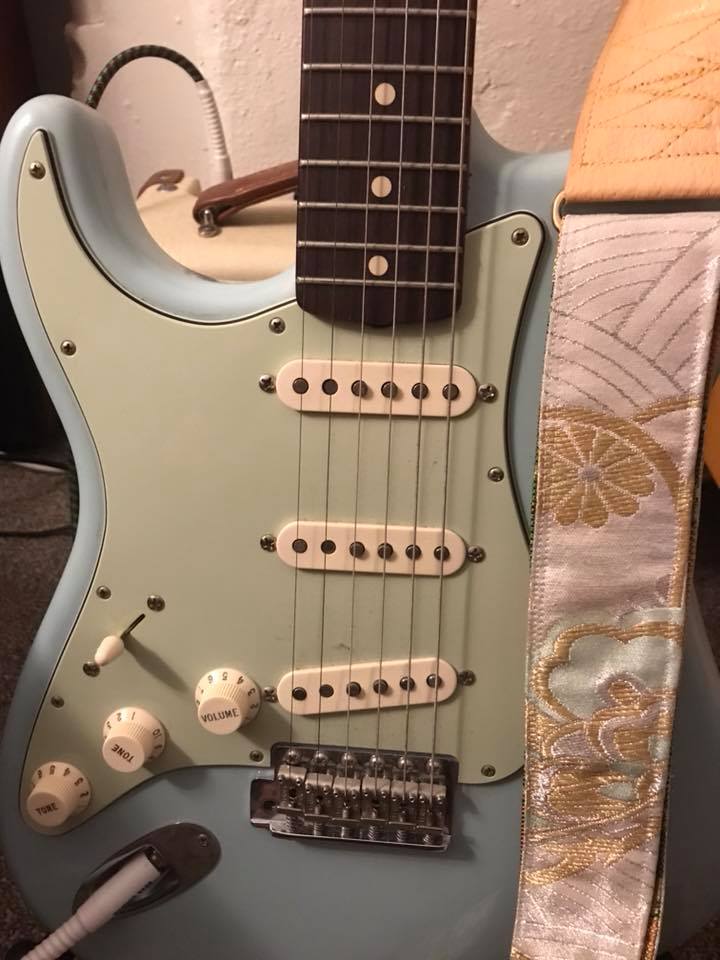 "63 left handed custom shop fender is sea foam green. Your strap brings out the best in us both."